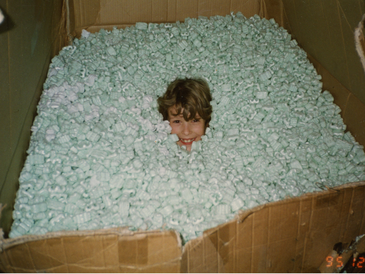 Alessandra as a child playing in packing peanuts at the Rosanna warehouse